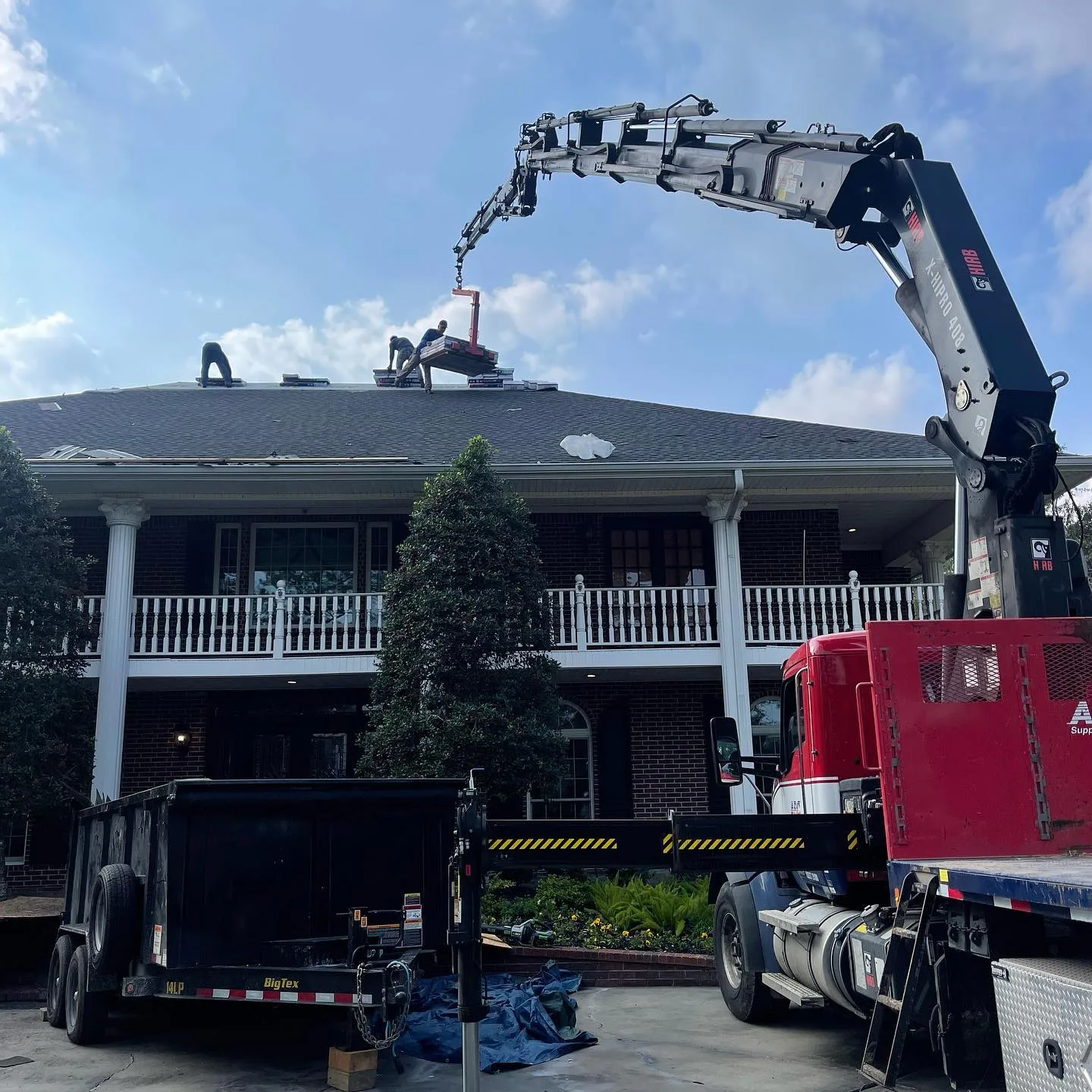 Roofing crew preparing a Baytown property for replacement