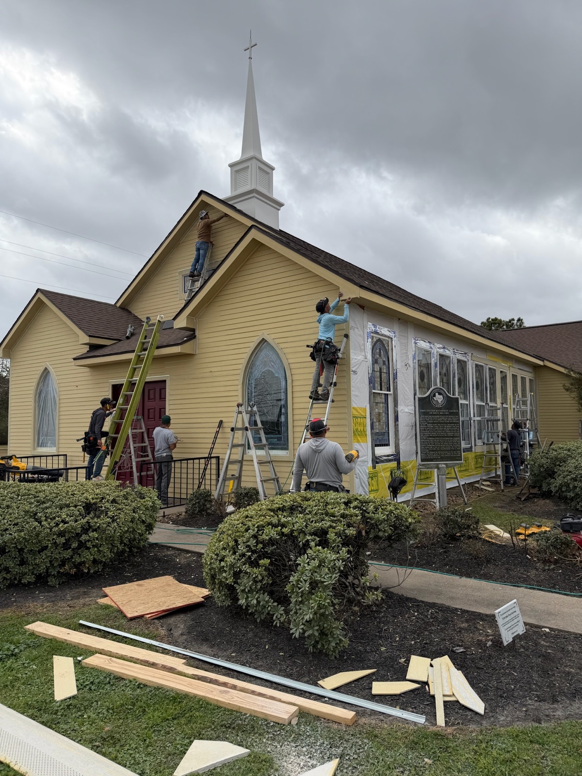 TAC crew working from ladders on a church exterior restoration project