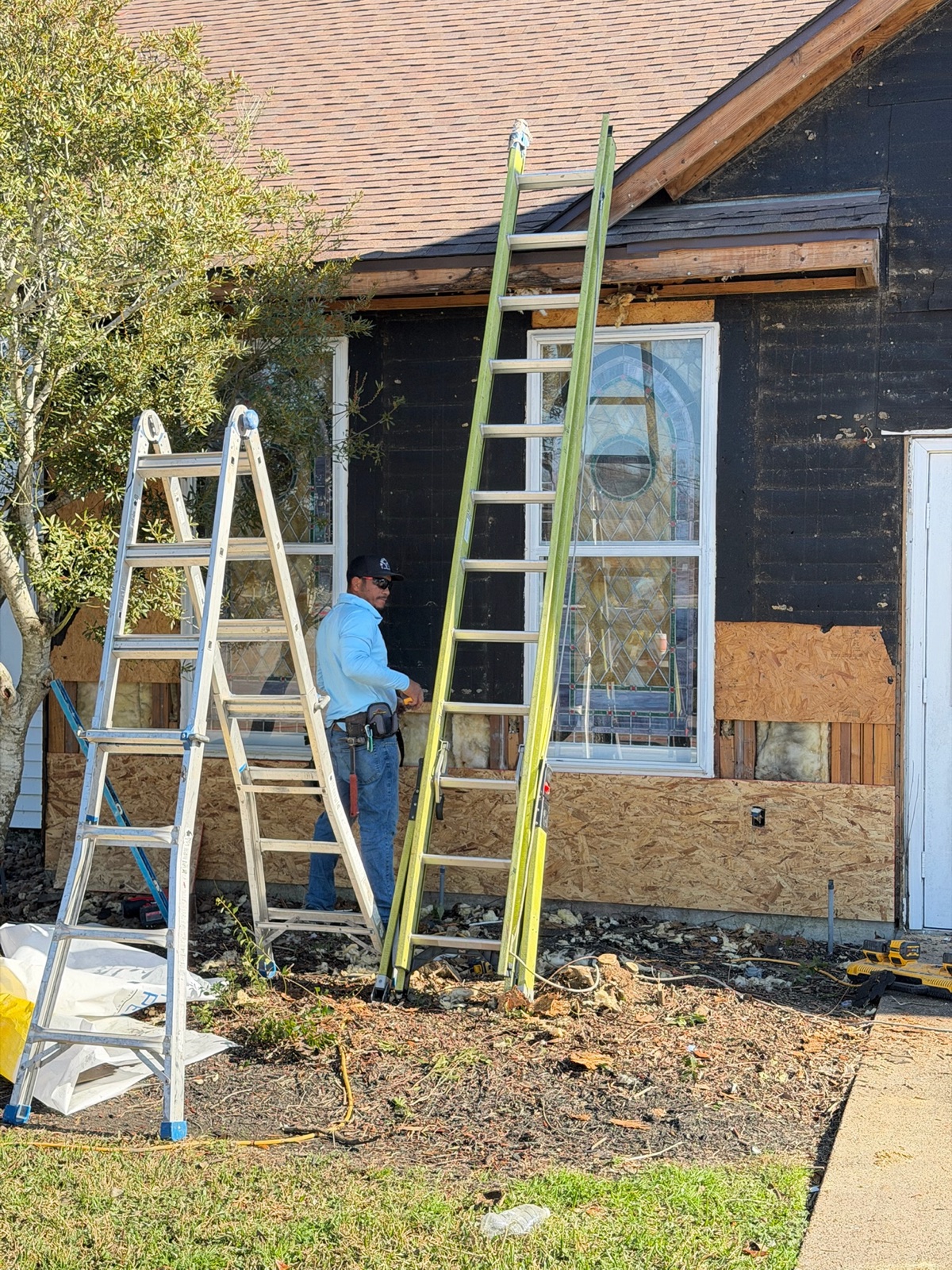 TAC crew detailing exterior wrap and trim around church windows