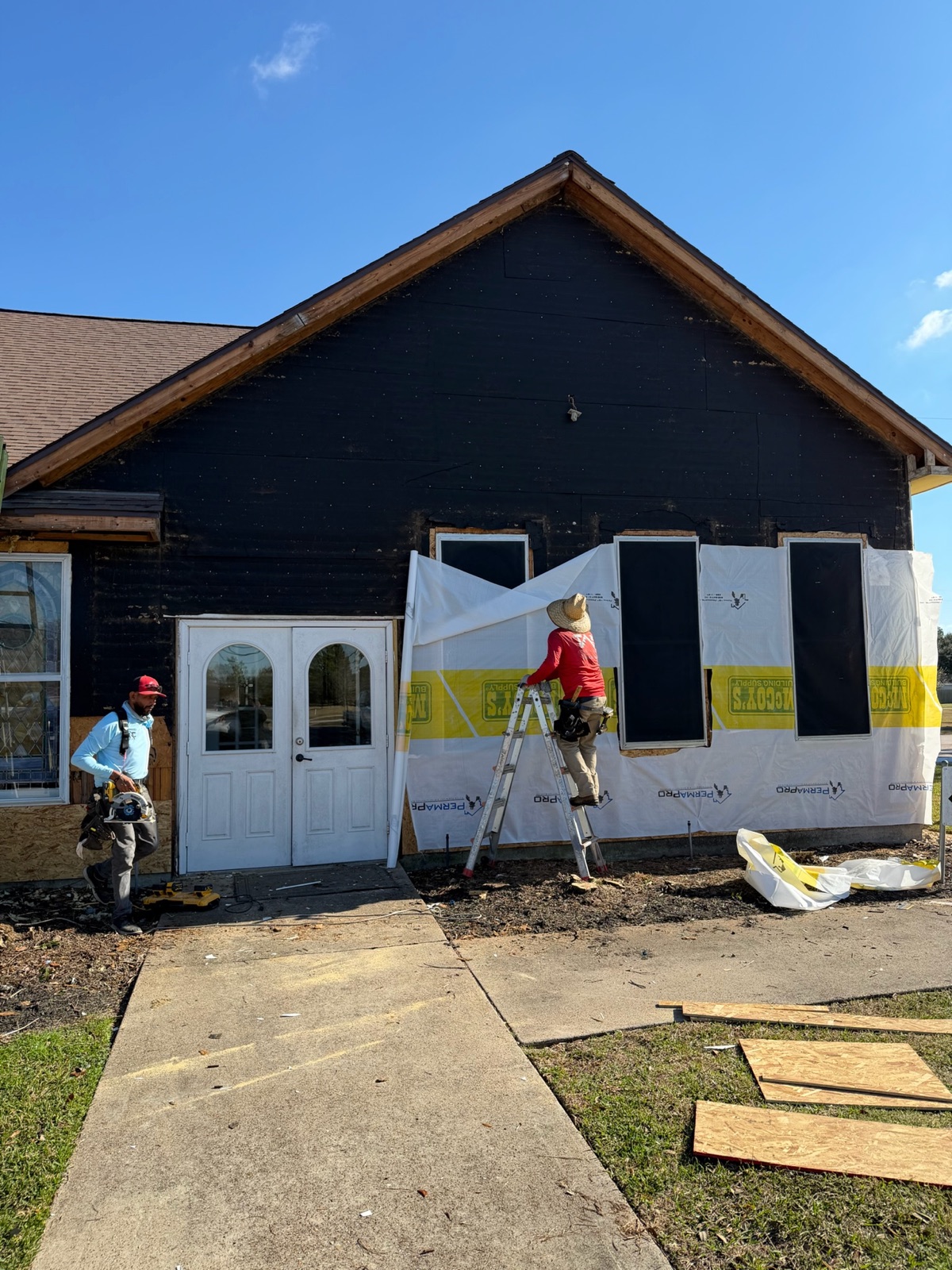 Church exterior opened for siding and weather barrier work