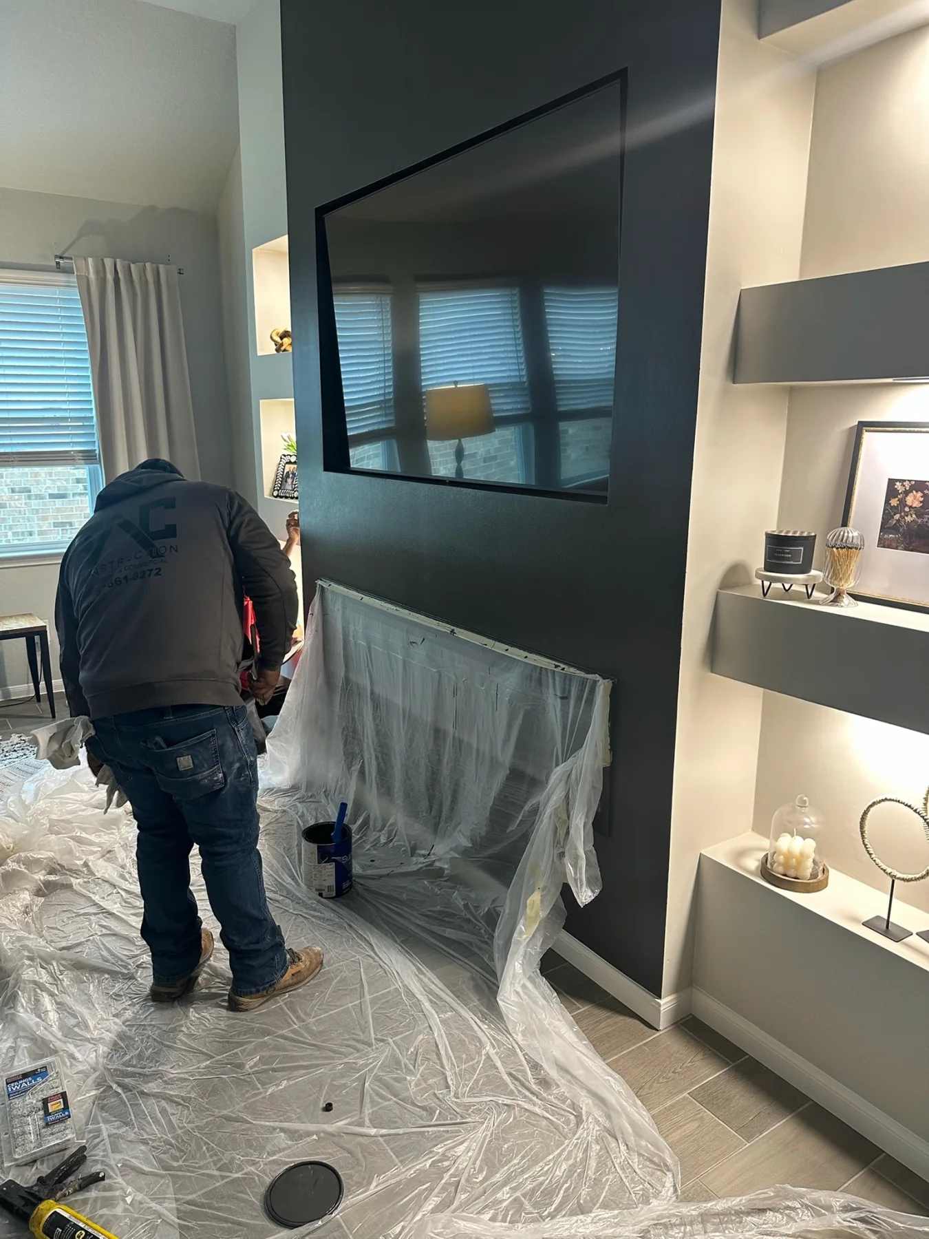 TAC crew protecting the room while finishing a custom media wall