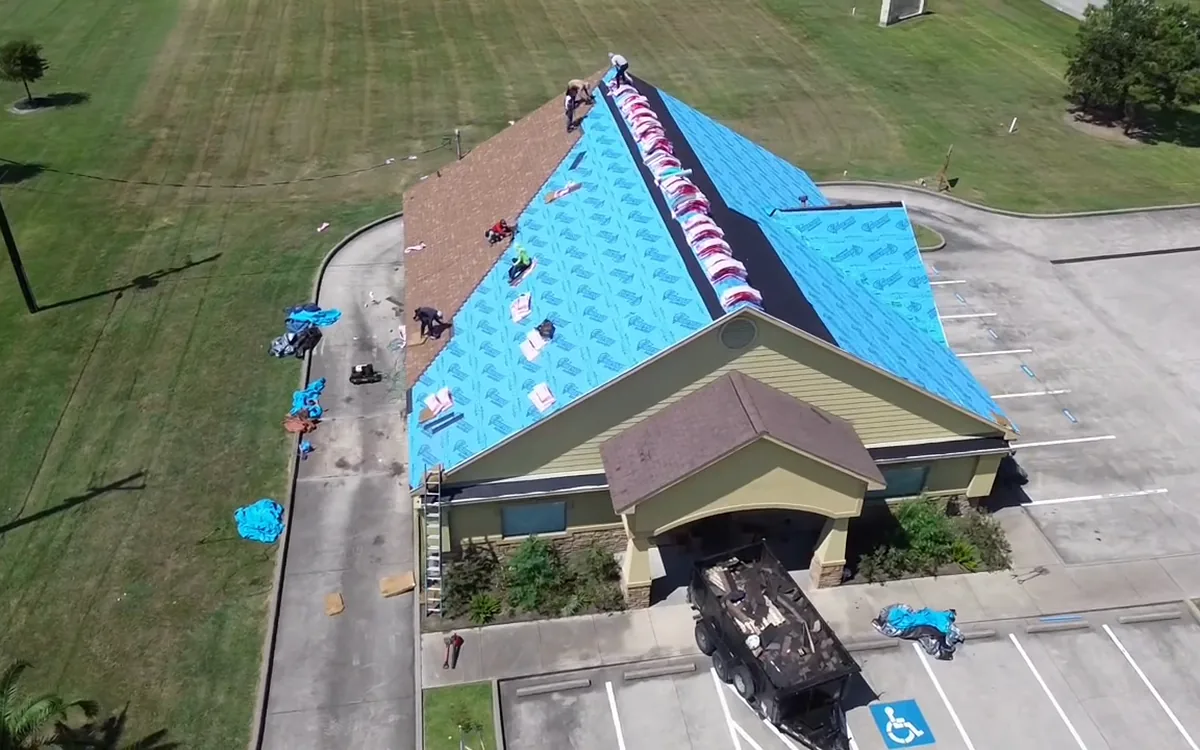Protective roof covering installed across an exposed roof