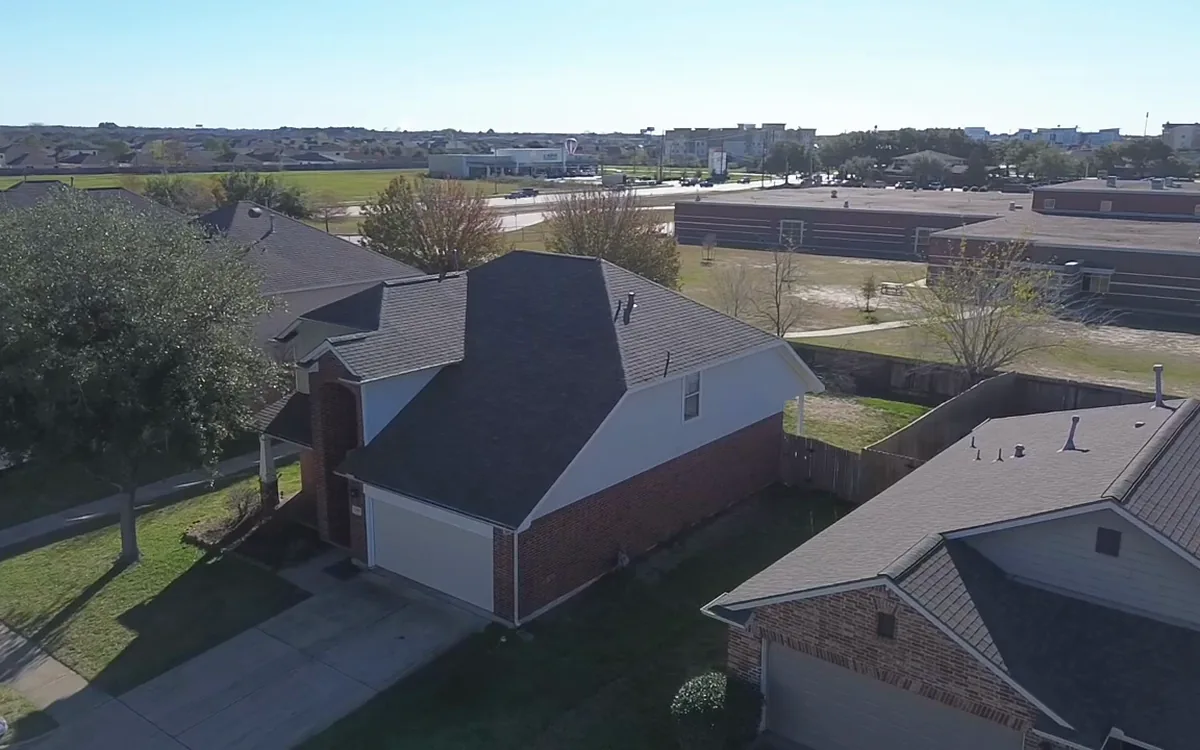 Aerial inspection view of a completed residential roof