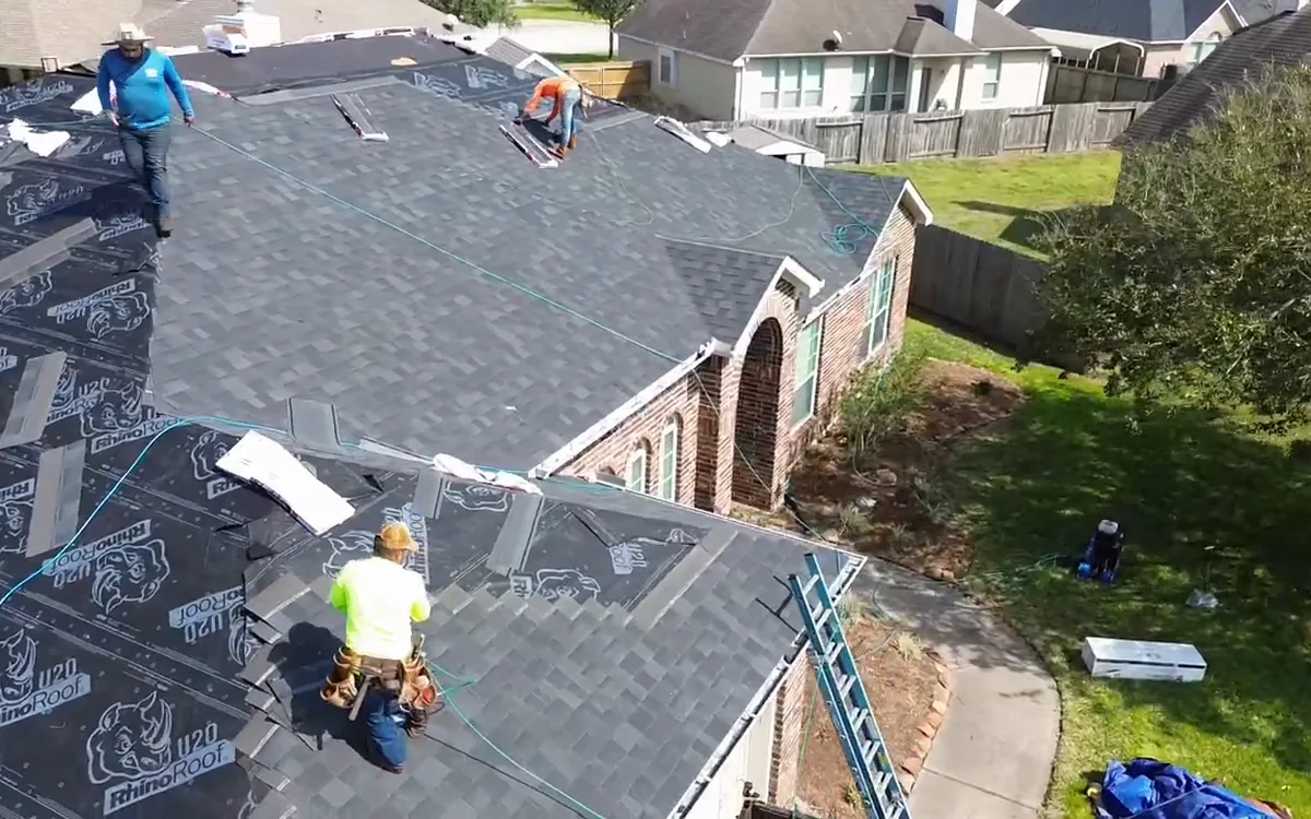 TAC roofers repairing shingles on a residential roof