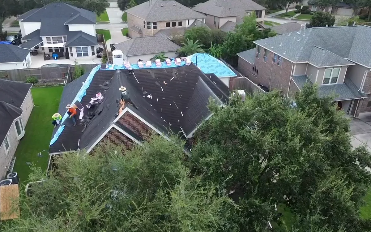 TAC crew restoring a residential roof with exposed areas protected during the work